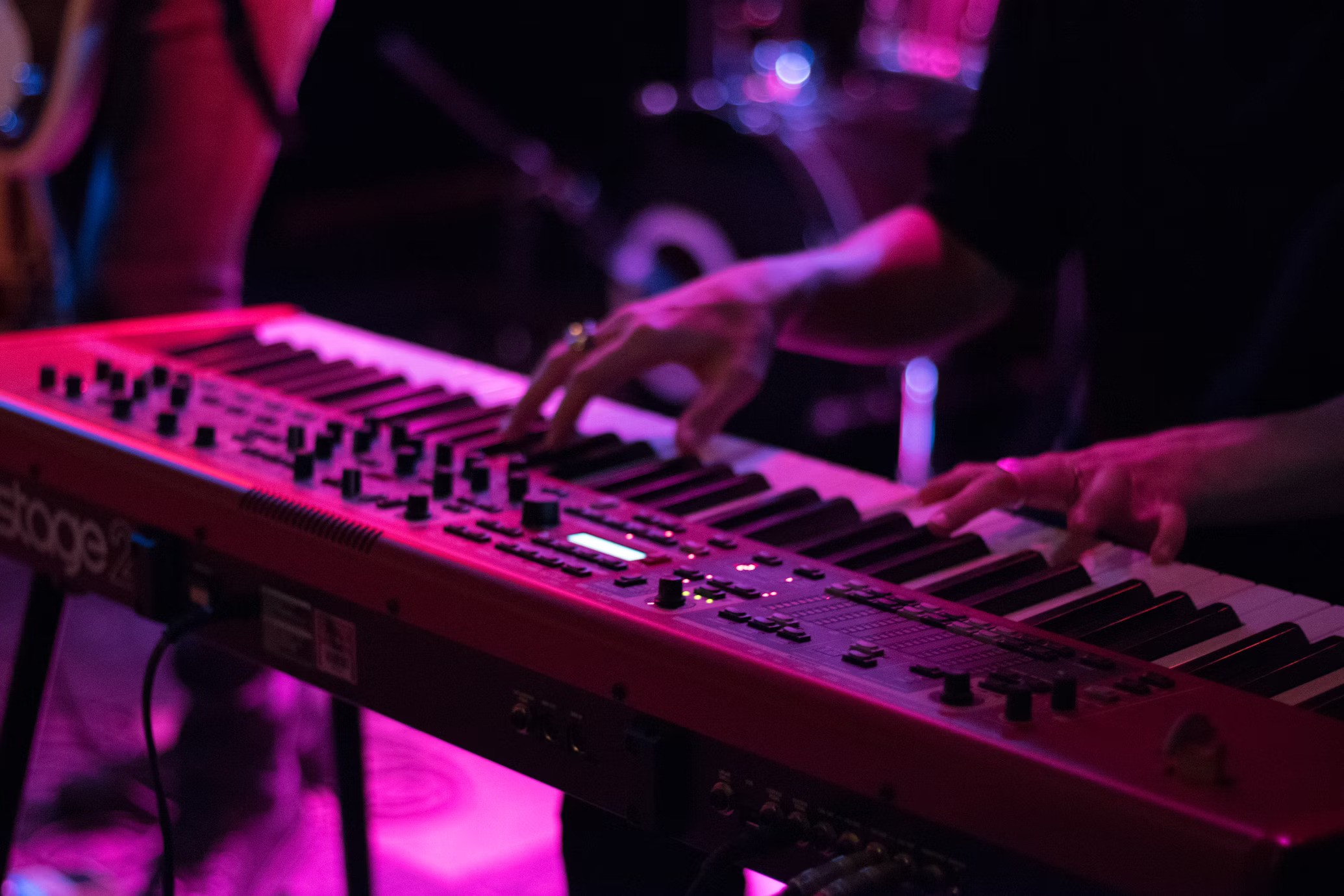 Student playing a keyboard in a music class